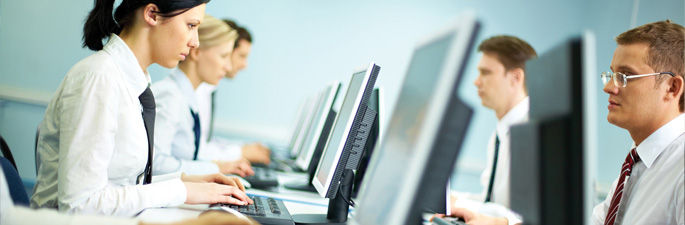 people typing on desktop computers